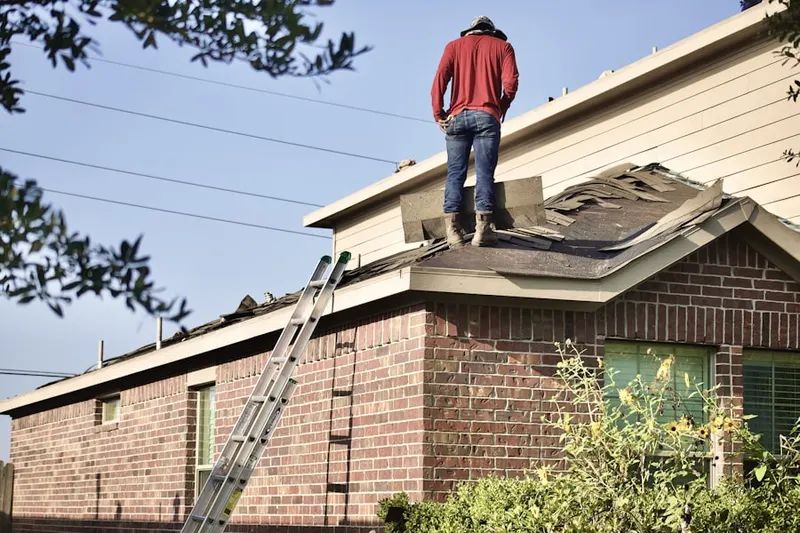 Professional roofer working on a residential roof in Dos Vientos